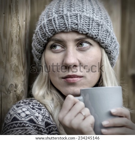 Beautiful blonde female drink coffee outdoor