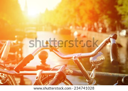 Amsterdam view with bicycles under sun light