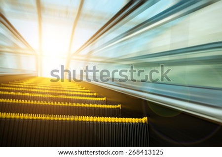 Blurry modern escalator at sunny day.