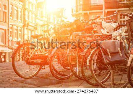 Amsterdam view with bicycles under sun light