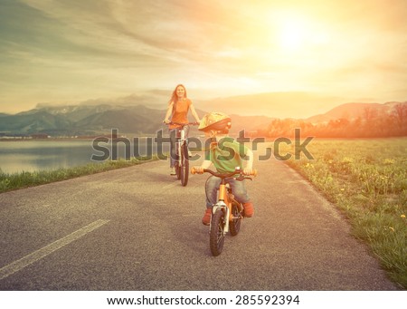 Happiness Mother and son on the bicycles funning outdoor