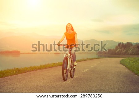Happiness woman on the bicycle outdoor.