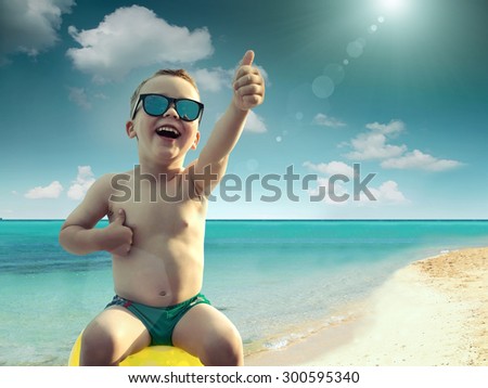 Child in sunglasses fun near the water under sunlight