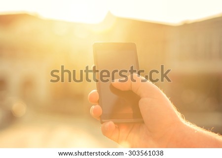 Man with telephone under sunlight
