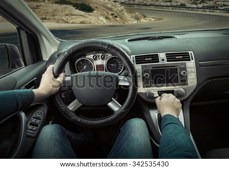 Man sitting and driving in the car.