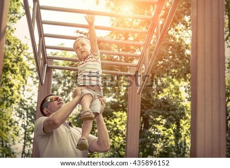 Father and son exercising outdoor.