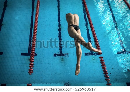 Swimmer man. Swimmings athlete after start jump to distance in waterpool.