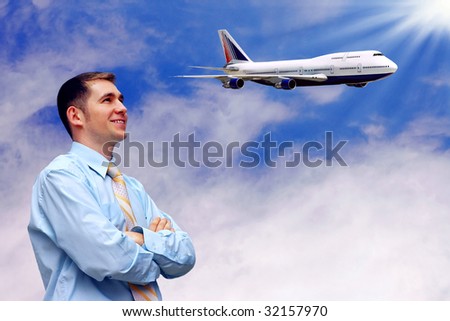 man looks at airplane in air with blue sky and sun