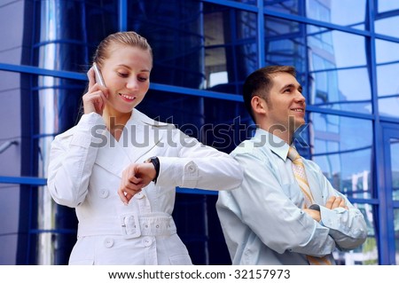 Business women in white and man on business architecture background
