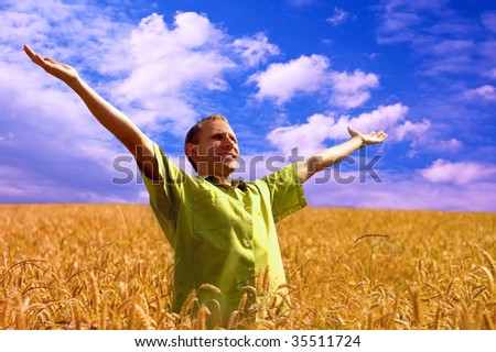 happiness men on the golden wheat field and blue sky