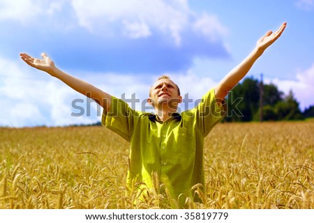 happiness men on the golden wheat field and blue sky