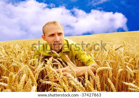 Happiness men on the golden wheat field and blue sky