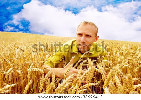 Happiness men on the golden wheat field and blue sky