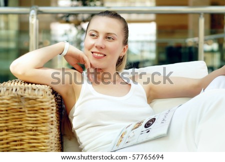 Happy woman in white with cup of coffee or tea at bedroom