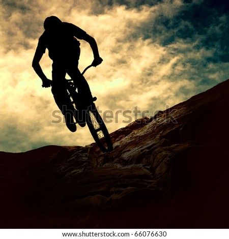 Silhouette of a man on muontain-bike sunset Silhouette of a man on muontain-bike sunset