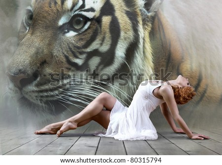 Woman dancer seating posing on wild annimals background