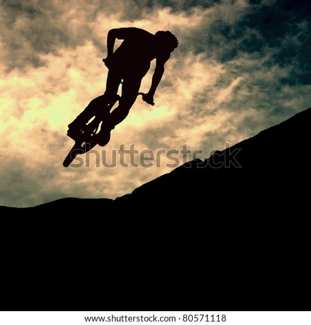 Silhouette of a man on mountain-bike, sunset