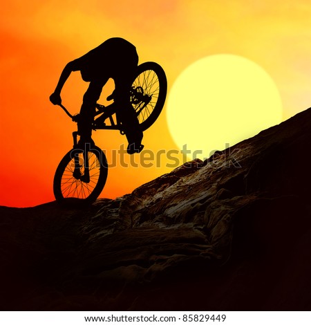 Silhouette of a man on mountain-bike, sunset
