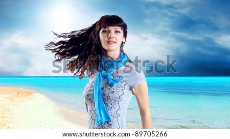 Young beatiful caucasian women with hair on the wind at sunny tropical beach