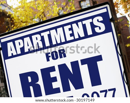 For rent sign in front of apartment building.