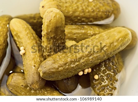 group of pickles, bathed in vinegar