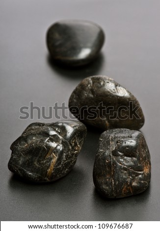 row of black stones; on black base