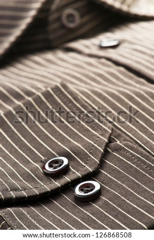 buttons, collar and sleeves of a striped shirt