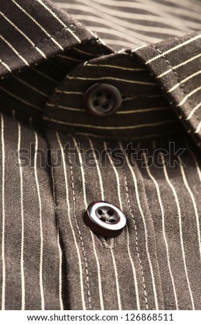 buttons, collar and sleeves of a striped shirt