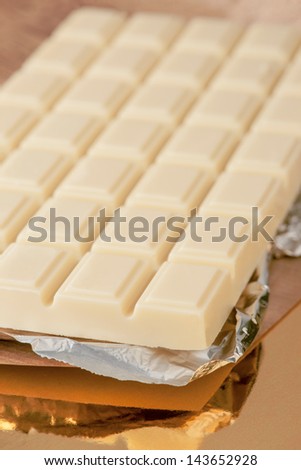 white chocolate bar on gold base and silver