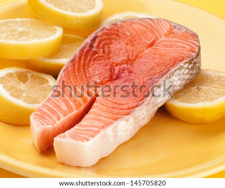 fillet of raw salmon on lemons isolated in target