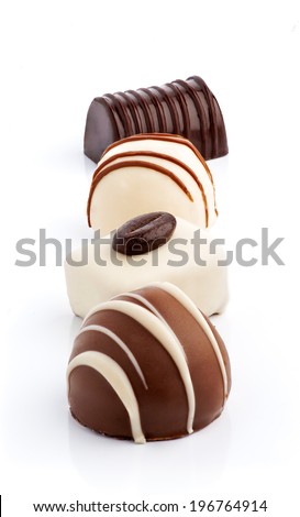 on line four chocolates isolated on white, all in focus