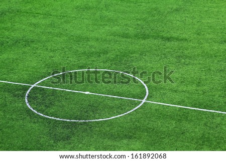 Green artificial grass soccer field for background