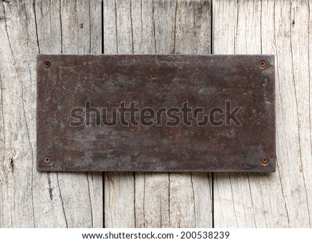 Metal sign on wood plank background