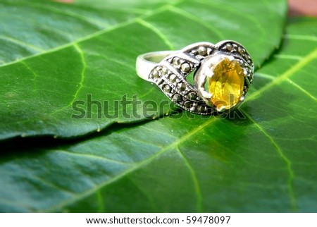 Yellow Gemstone Ring with Green Leaves