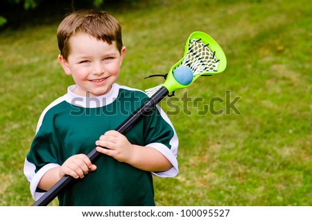 Happy young child lacrosse player with his stick