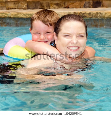 Mother and son swimming together while on vacation