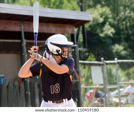 Young teen girl playing softball in organized game