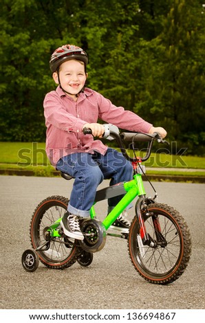 Child riding bike with safety helmet outdoors