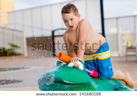 Child playing with water toy at kiddie pool during summer