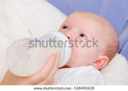 Infant baby feeding from bottle