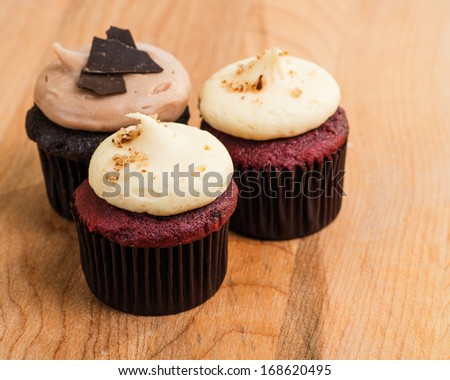 Trio of chocolate and red velvet mini cupcakes with cream cheese frosting
