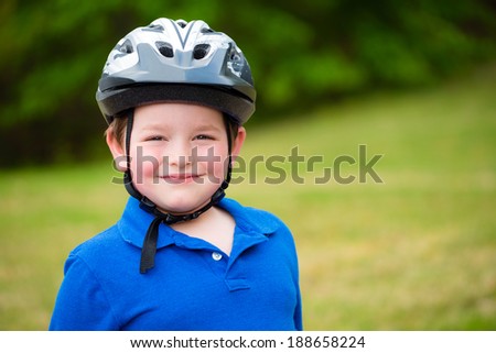 Happy child wearing a bike helmet outdoors