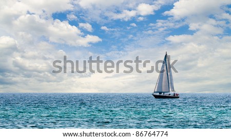 Sailboat on light blue water off Florida Gulf Coast