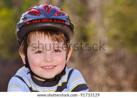 Young boy wearing safety helmet for bike riding