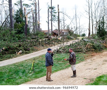 DALLAS, GA-MARCH 3: Unidentified homeowners talk outside their tornado-damaged property in Dallas, GA, on March 3, 2012.  Tornadoes ripped through the Southeast and Midwest on March 2, 2012.
