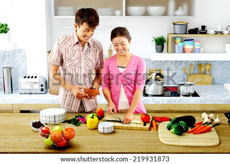 Young couple cooking - Men and women in the kitchen preparing food