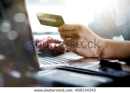 Online shopping.Hands holding credit card and using laptop.