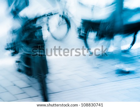 people on motor bike and bicycle at big city street, blurred motion abstract,