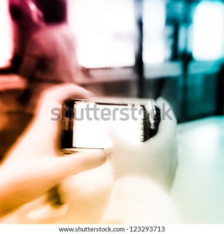 business women using cell phone on subway station blur motion