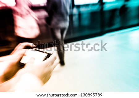 business women using cell phone on subway station blur motion